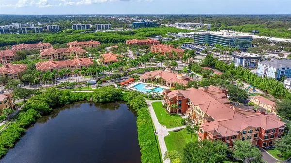 an aerial view of lake residential houses with outdoor space and swimming pool