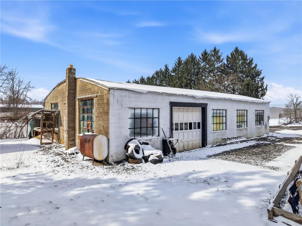 7376 Sharon-Mercer Road Mercer, PA 16137 - Photo 5 of 50 37x60 garage with concrete floor, wood burner heat w/ drop duct work, office & electric