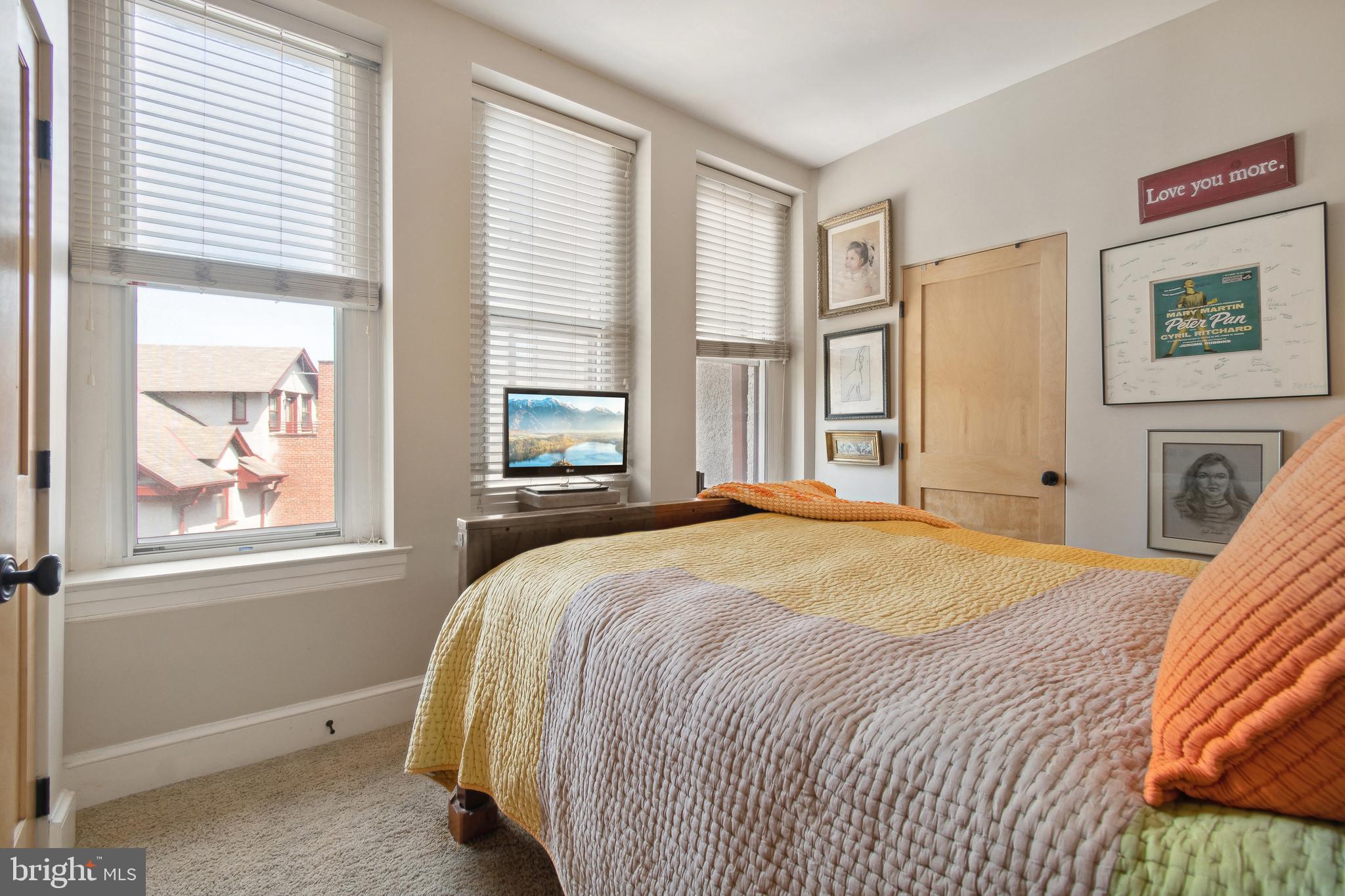 9610 Dewitt Drive, Unit B312 Silver Spring, MD 20910 - Photo 11 of 23 a bedroom with a bed and a window