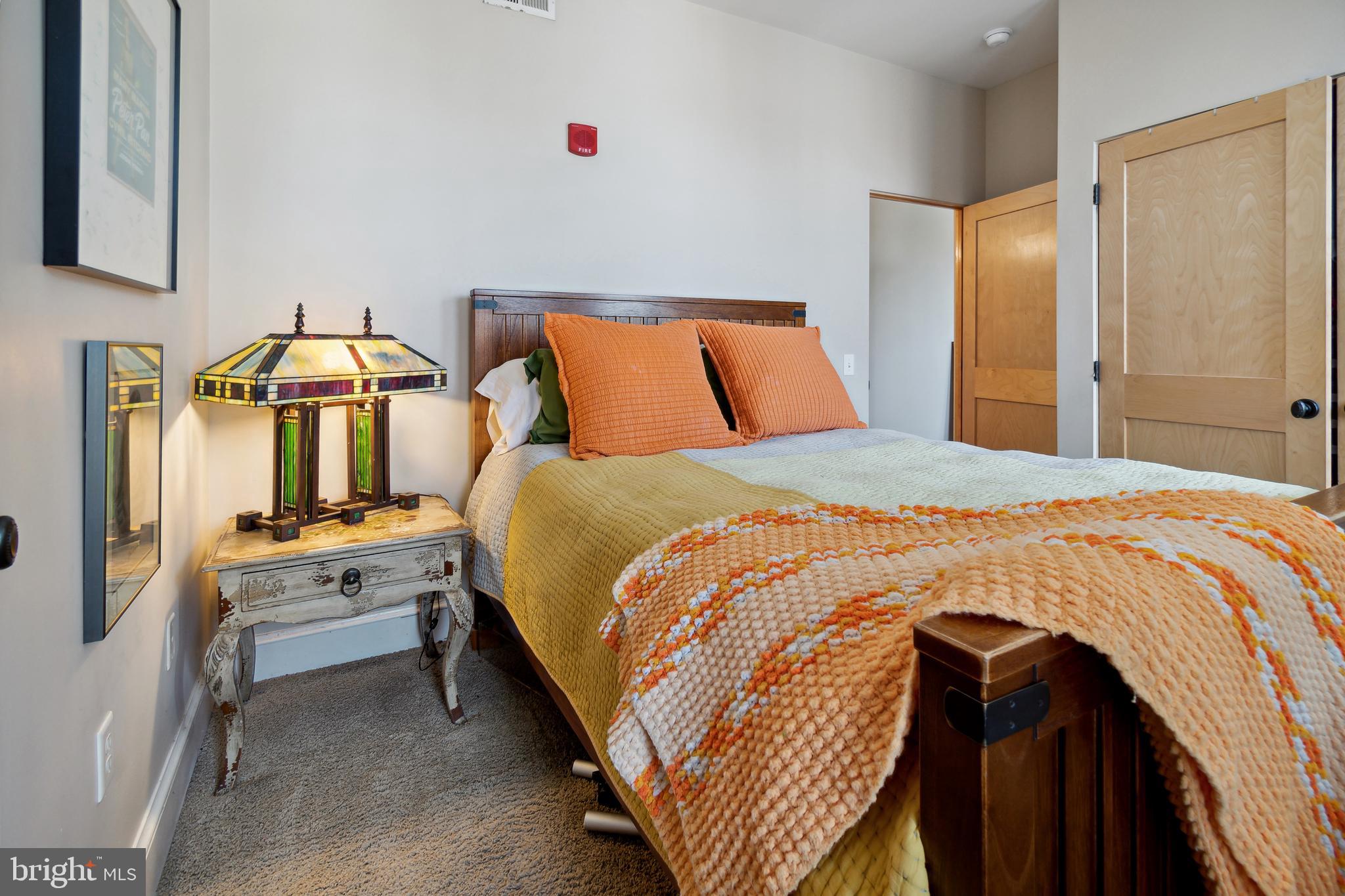 9610 Dewitt Drive, Unit B312 Silver Spring, MD 20910 - Photo 12 of 23 a bedroom with a bed and a chandelier