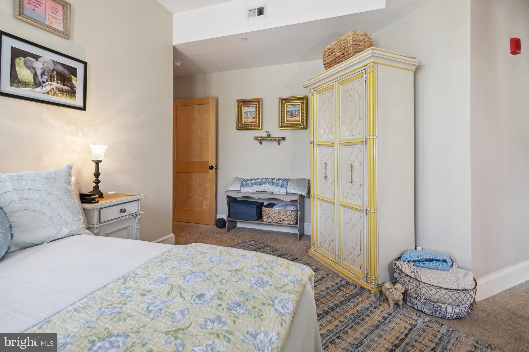 9610 Dewitt Drive, Unit B312 Silver Spring, MD 20910 - Photo 15 of 23 a bedroom with a bed and wooden floor