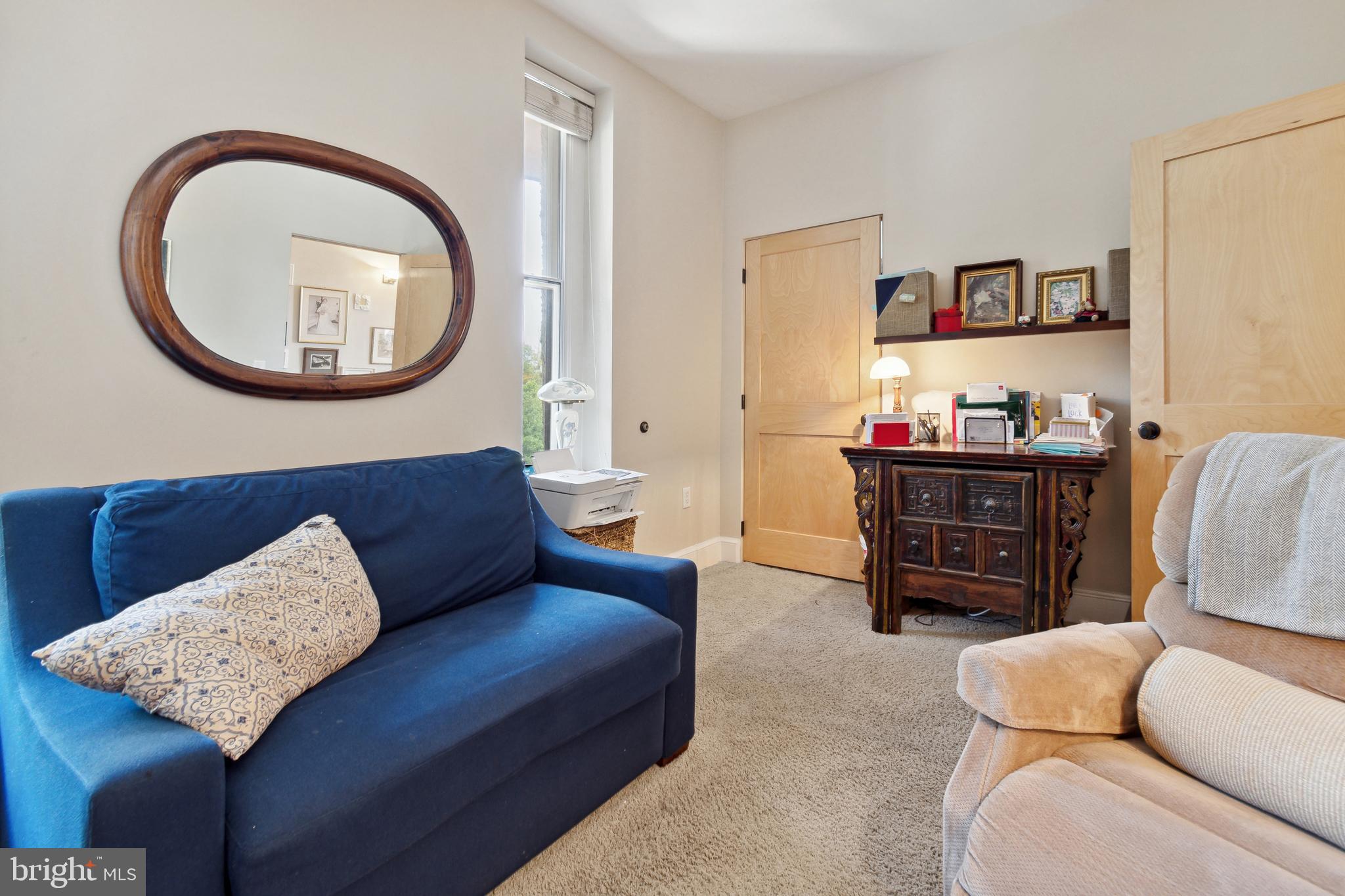 9610 Dewitt Drive, Unit B312 Silver Spring, MD 20910 - Photo 18 of 23 a living room with furniture and a large mirror