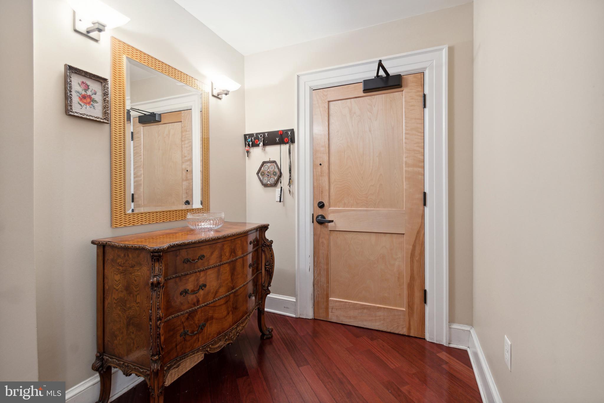 9610 Dewitt Drive, Unit B312 Silver Spring, MD 20910 - Photo 2 of 23 a room with a table and a mirror