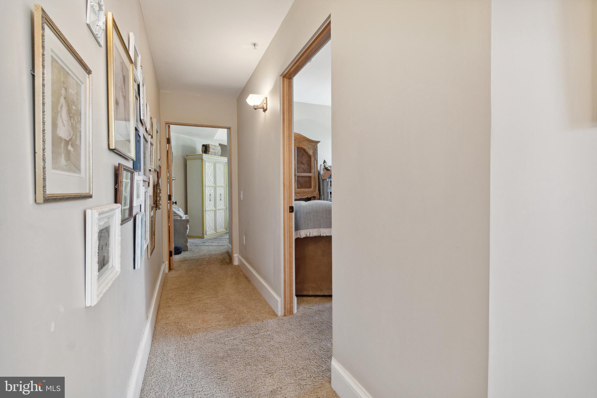 9610 Dewitt Drive, Unit B312 Silver Spring, MD 20910 - Photo 4 of 23 a view of a hallway with wooden floor and a bathroom