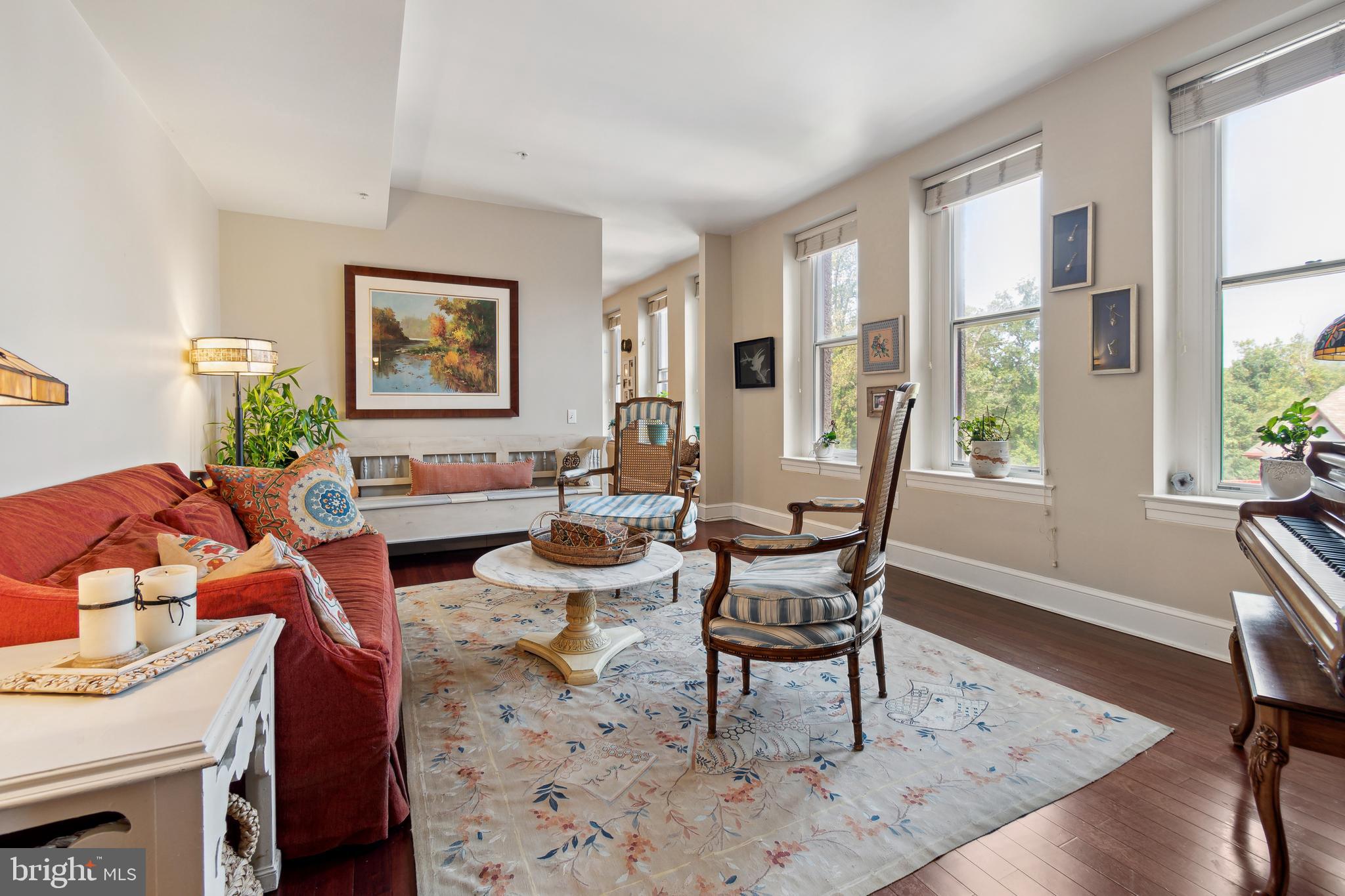 9610 Dewitt Drive, Unit B312 Silver Spring, MD 20910 - Photo 5 of 23 a living room with furniture a large window and wooden floor