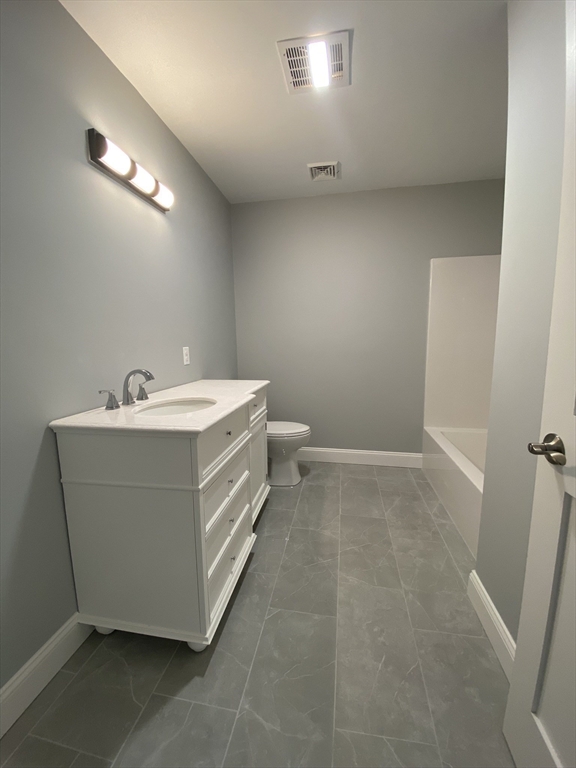 855 County Street, Unit 2 Attleboro, MA 02703 - Photo 15 of 27 a bathroom with a sink a toilet and a mirror