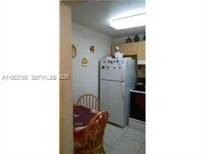 a kitchen with a refrigerator and cabinets