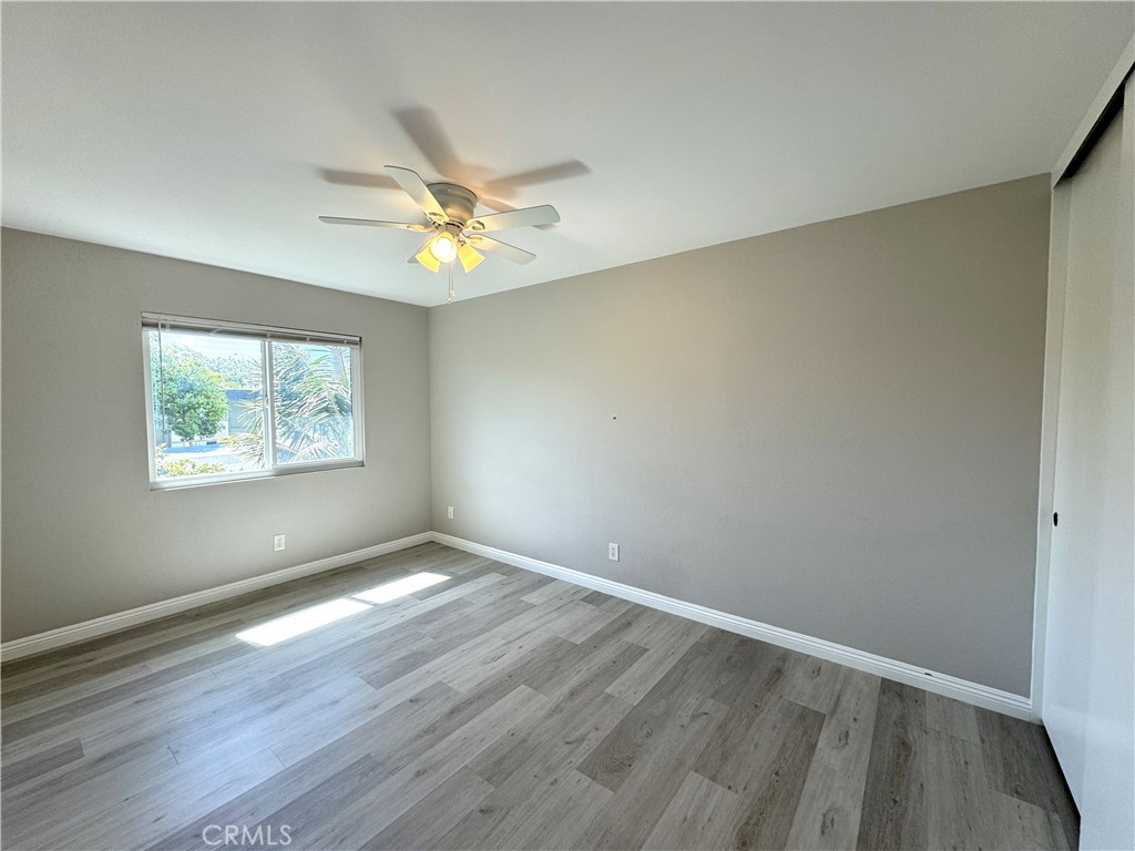 700 West Walnut Avenue, Unit 8 Orange, CA 92868 - Photo 11 of 11 an empty room with wooden floor and windows