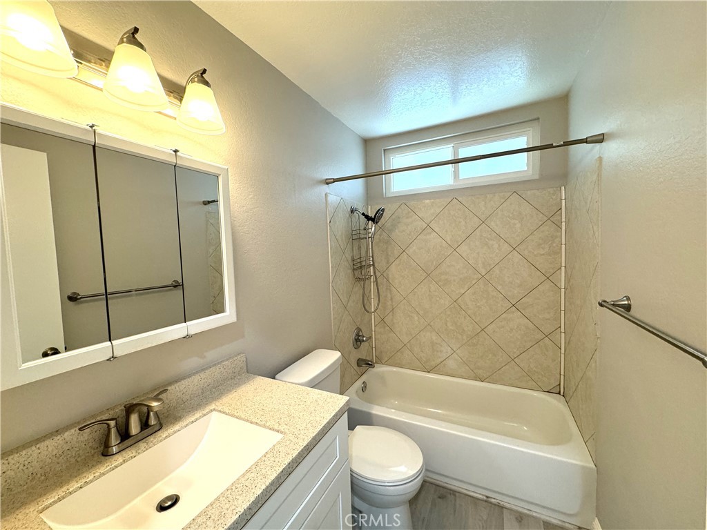 700 West Walnut Avenue, Unit 8 Orange, CA 92868 - Photo 10 of 11 a bathroom with a sink mirror toilet and bathtub