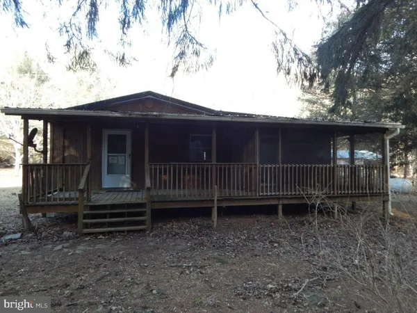a view of a deck with a chair and table and chairs with wooden fence