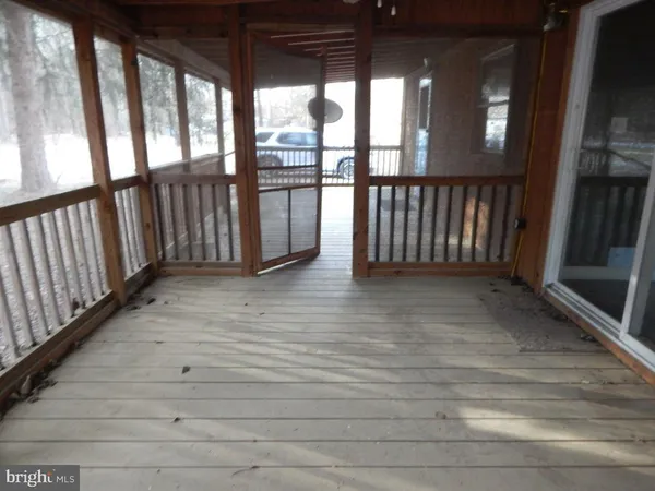 a view of staircase with railing and flat screen tv