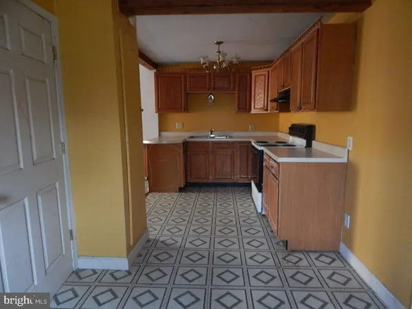 a kitchen with stainless steel appliances a stove a microwave and cabinets