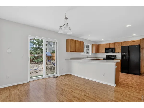 a kitchen with granite countertop a refrigerator and a sink