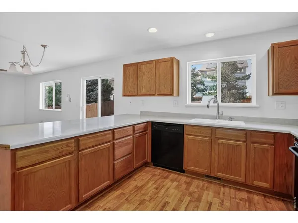 a kitchen with cabinets and wooden floor