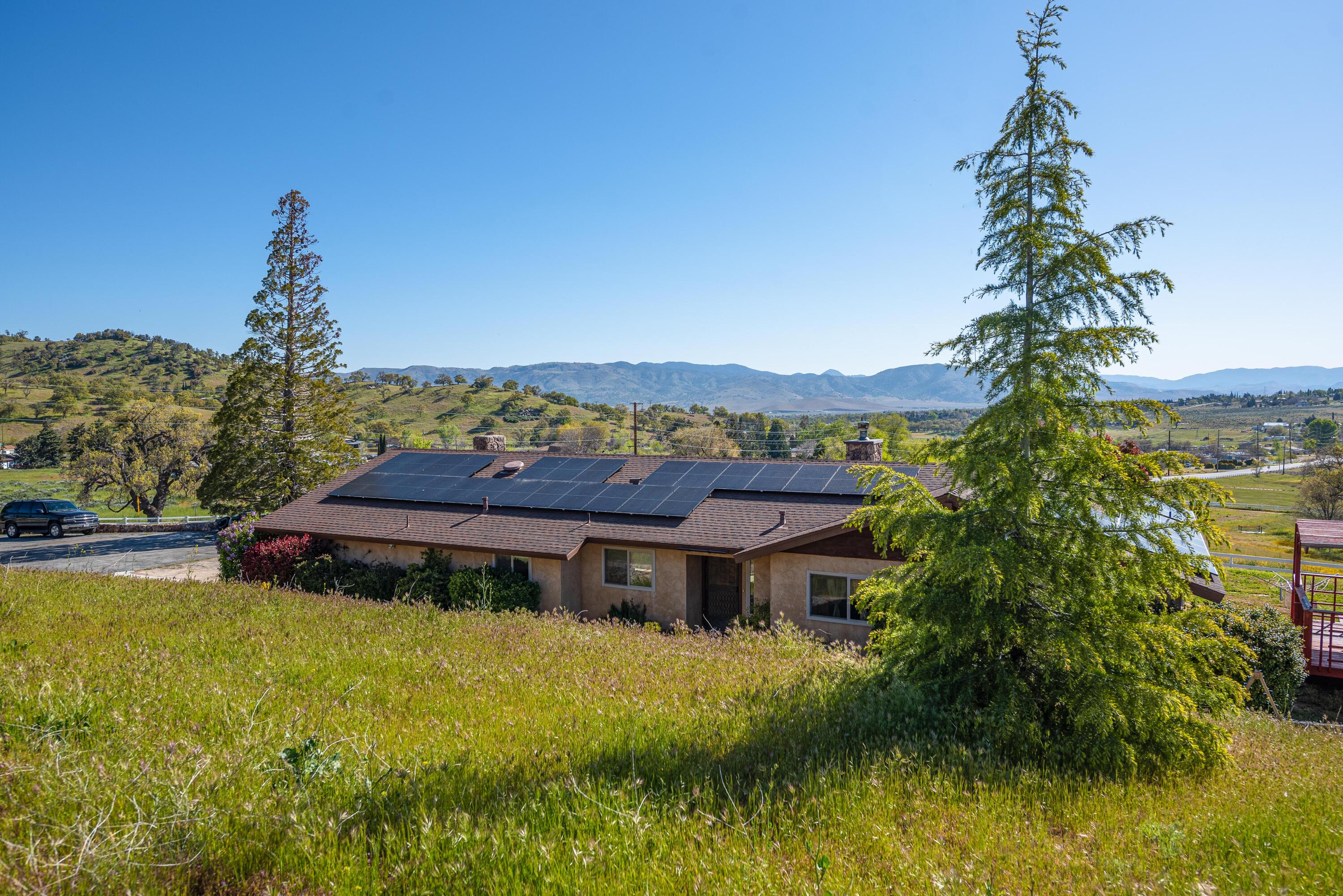 21970 Highline Road Tehachapi, CA 93561 - Photo 11 of 68 a view of a house with a yard and a swimming pool