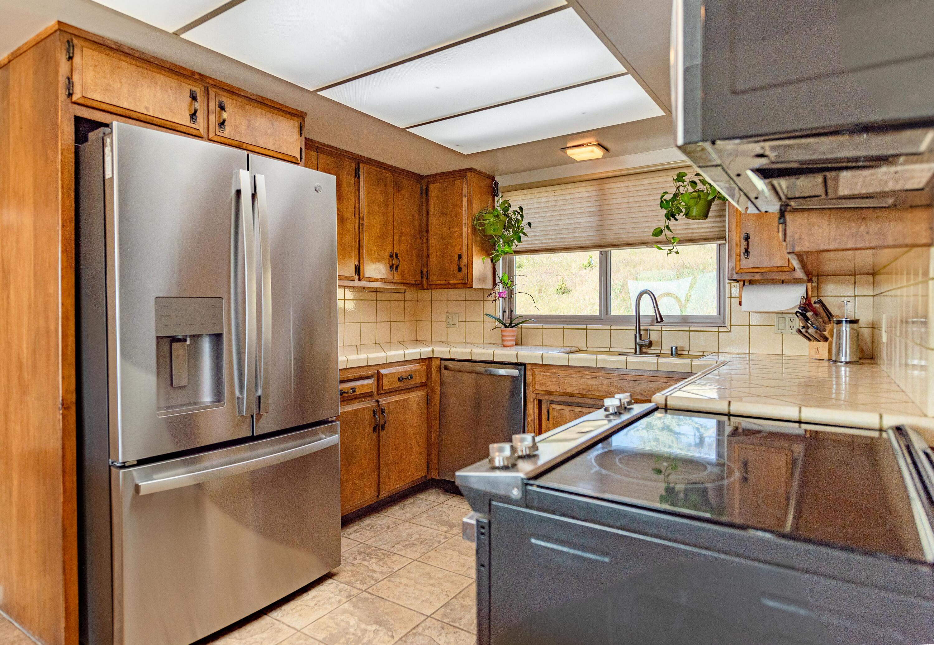 21970 Highline Road Tehachapi, CA 93561 - Photo 34 of 68 a kitchen with stainless steel appliances granite countertop a refrigerator and a sink