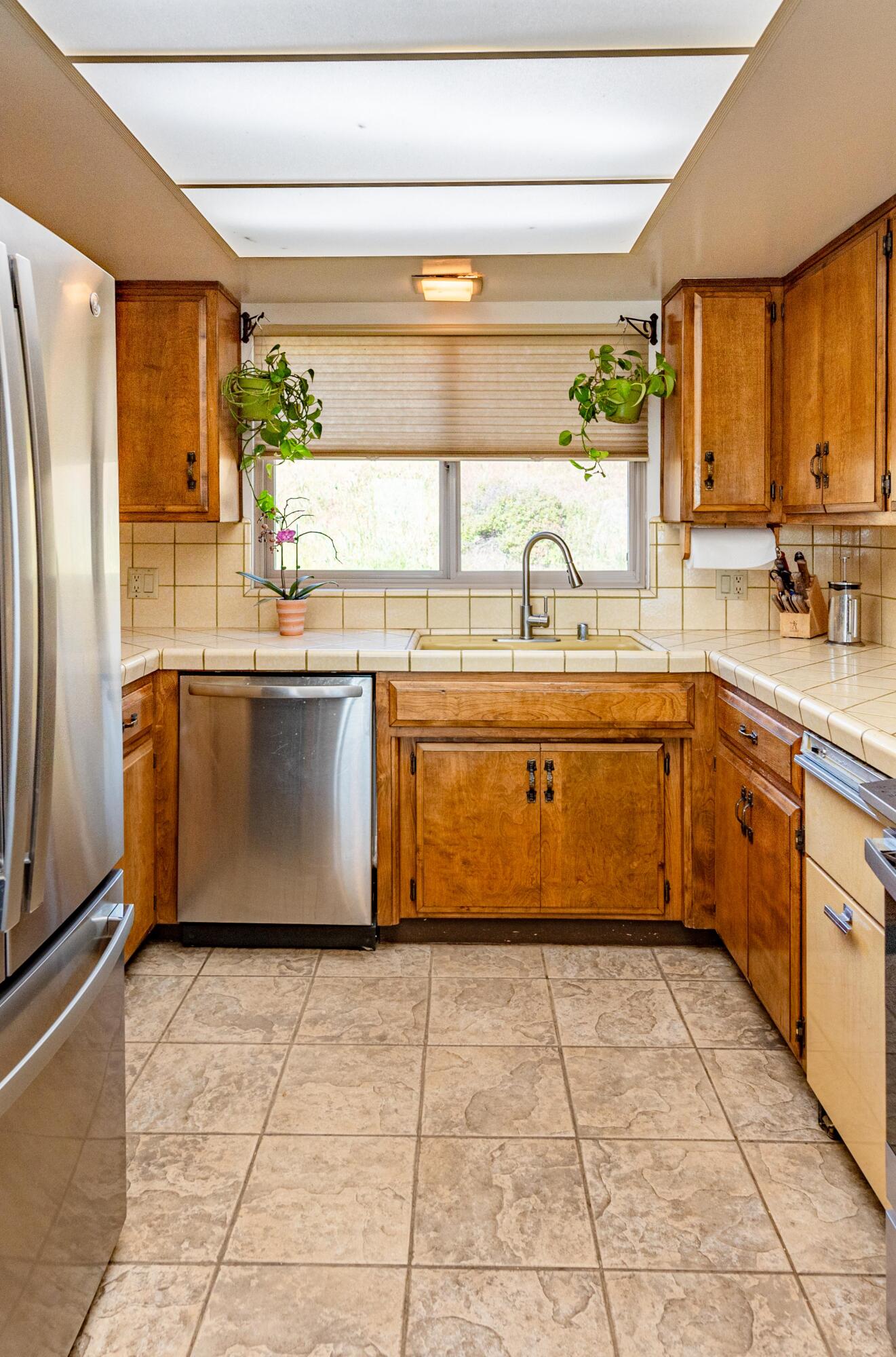 21970 Highline Road Tehachapi, CA 93561 - Photo 35 of 68 a kitchen with stainless steel appliances granite countertop a sink and a refrigerator