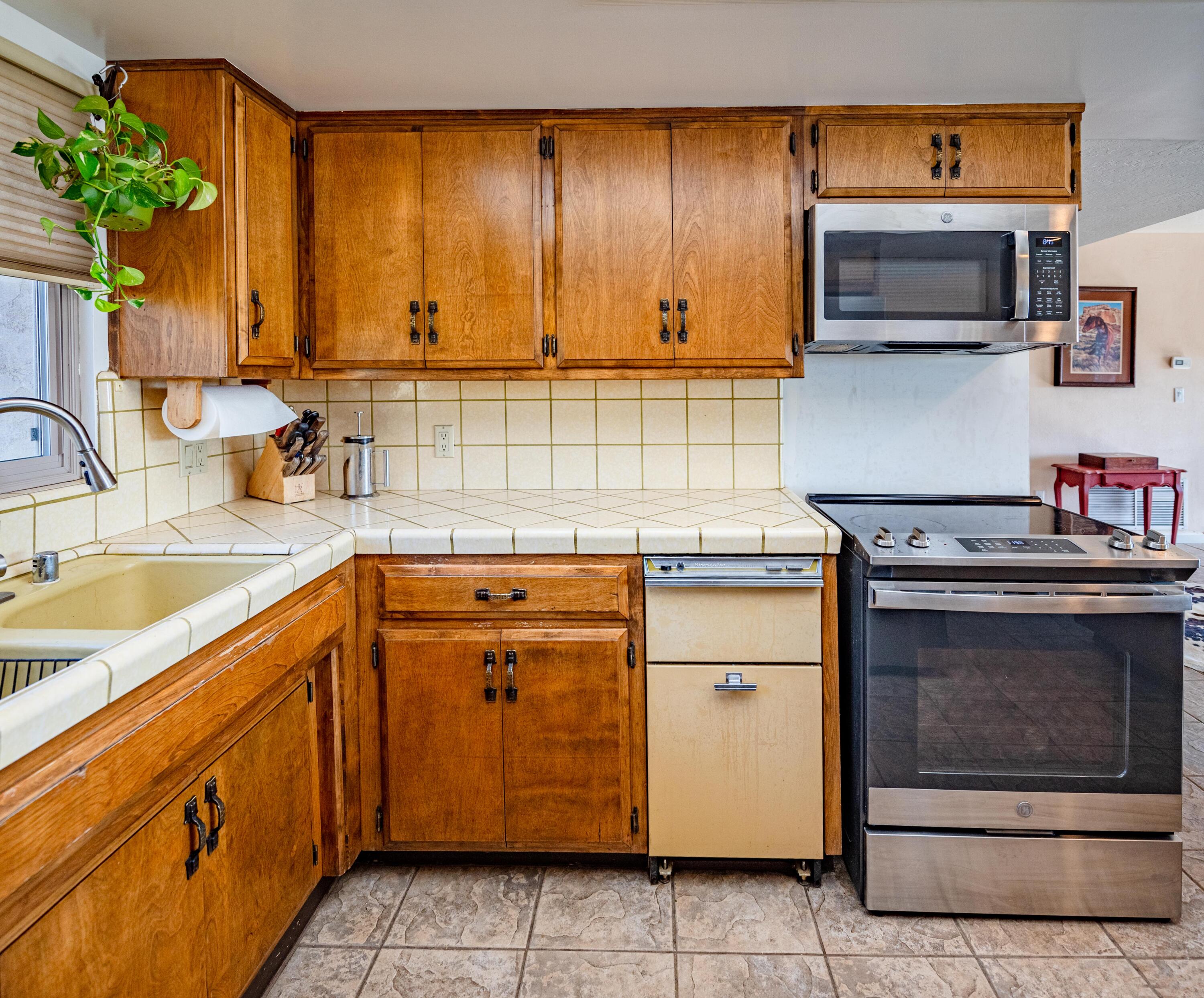 21970 Highline Road Tehachapi, CA 93561 - Photo 36 of 68 a kitchen with stainless steel appliances granite countertop a sink stove and microwave