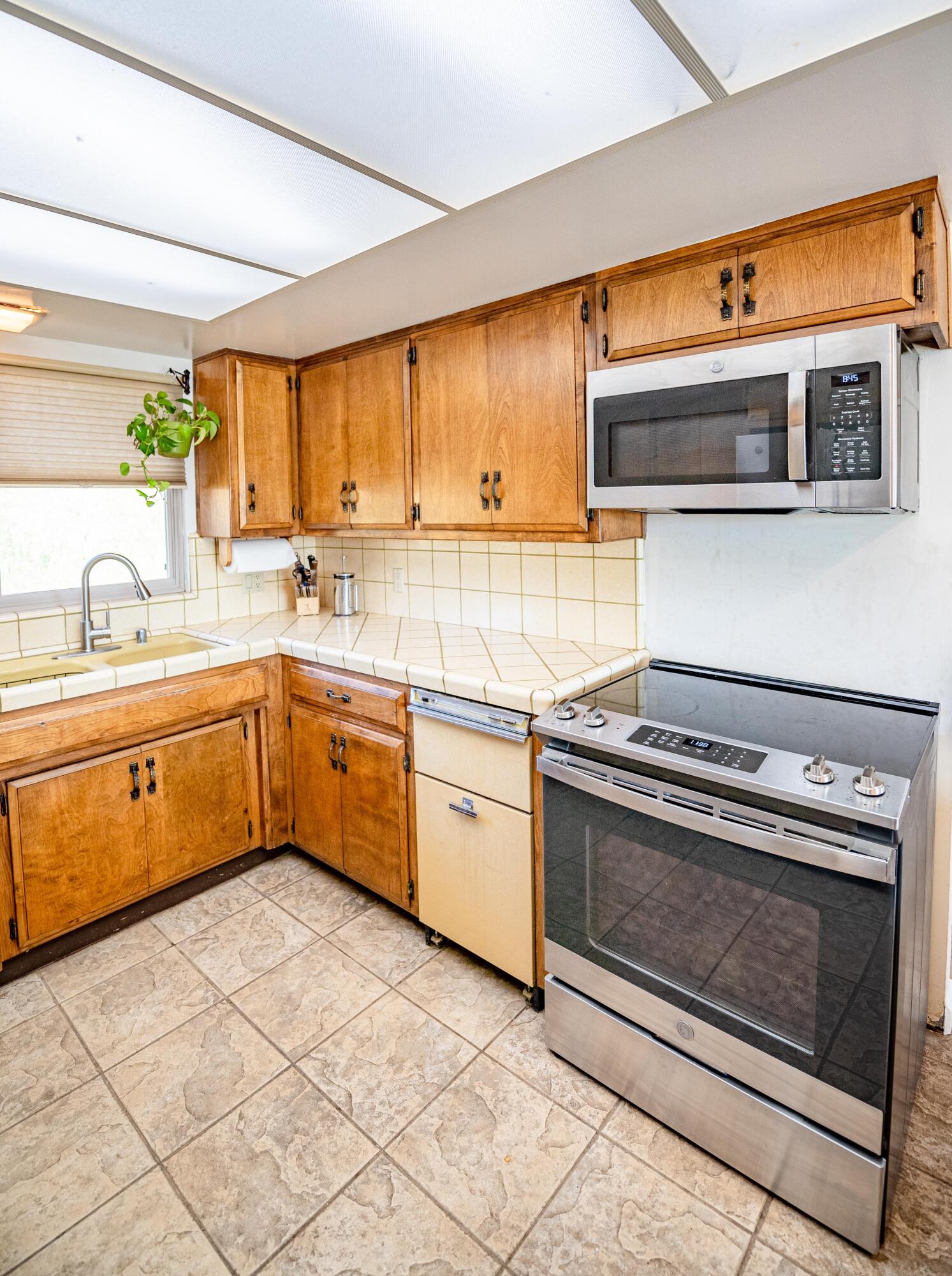 21970 Highline Road Tehachapi, CA 93561 - Photo 37 of 68 a kitchen with stainless steel appliances a stove a sink and a microwave