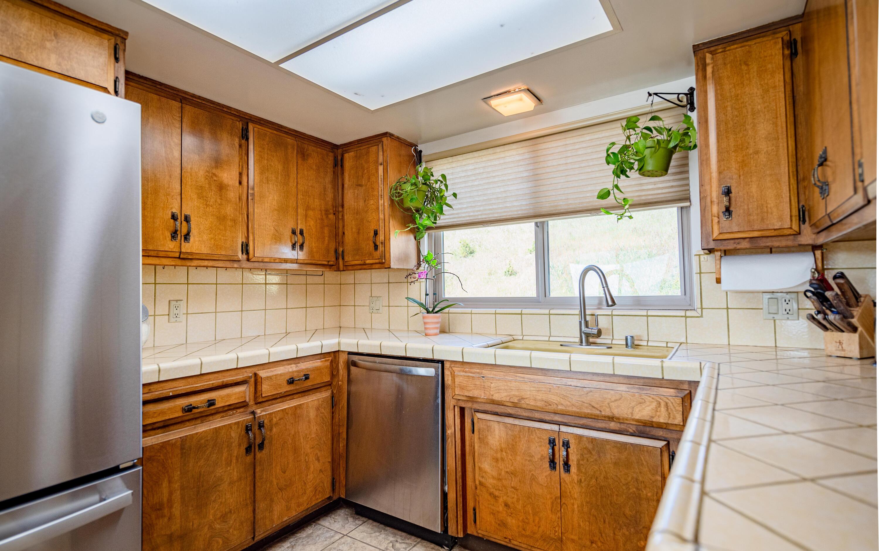 21970 Highline Road Tehachapi, CA 93561 - Photo 38 of 68 a kitchen with stainless steel appliances a sink cabinets and a window