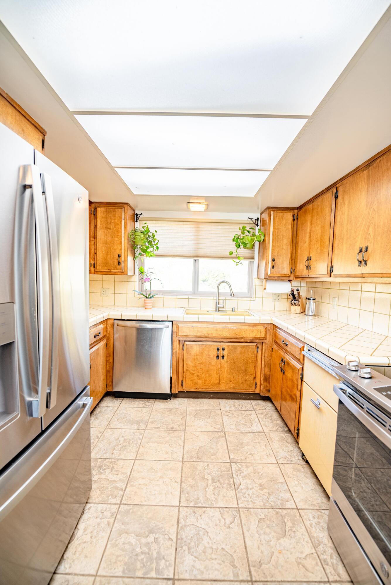 21970 Highline Road Tehachapi, CA 93561 - Photo 39 of 68 a kitchen with stainless steel appliances a stove sink and cabinets
