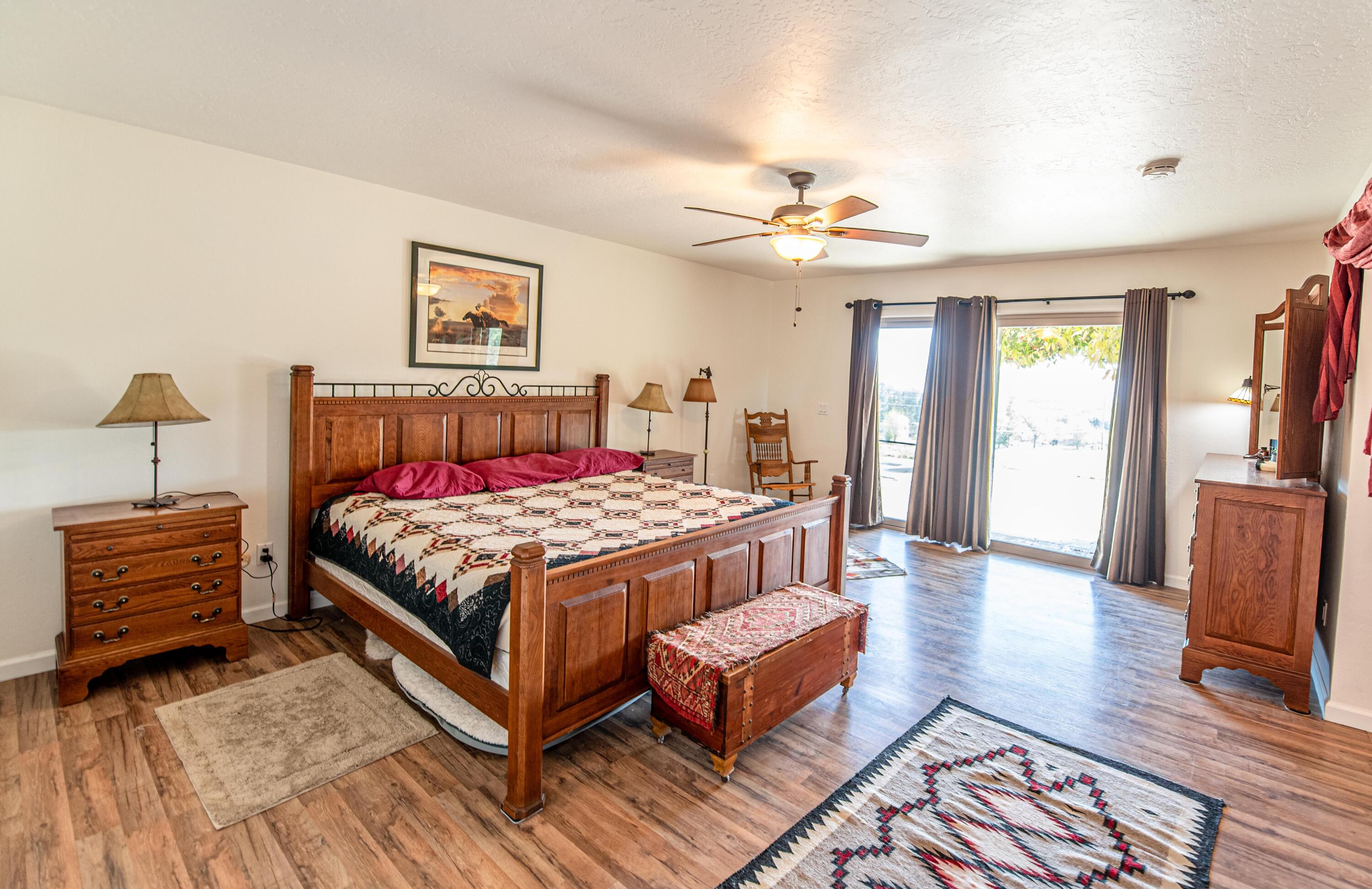 21970 Highline Road Tehachapi, CA 93561 - Photo 44 of 68 a bedroom with a bed and wooden floor