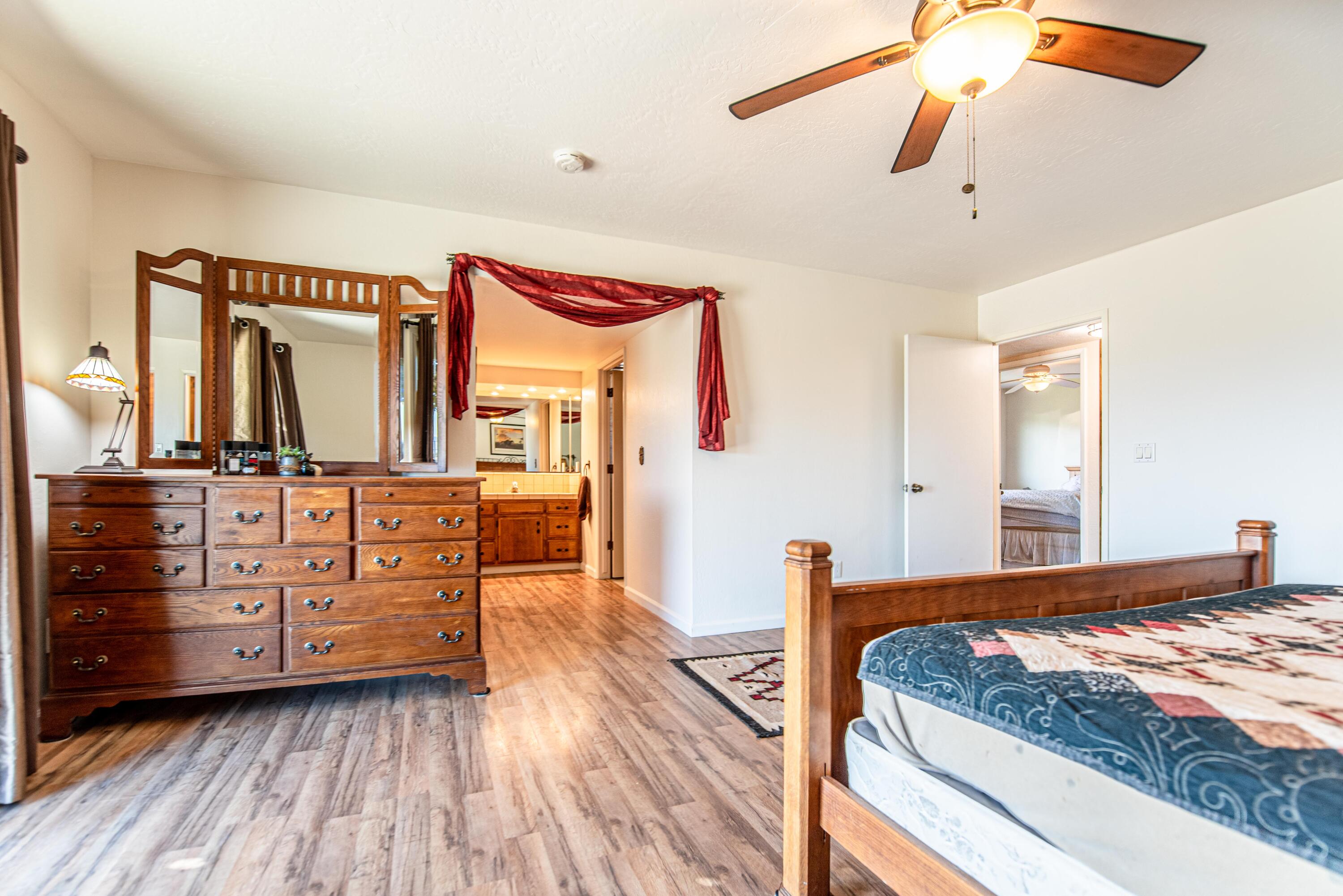 21970 Highline Road Tehachapi, CA 93561 - Photo 46 of 68 a bedroom with a bed and wooden floor