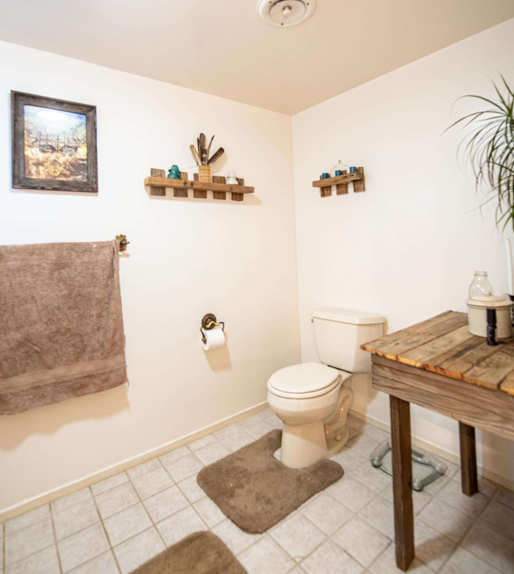 21970 Highline Road Tehachapi, CA 93561 - Photo 48 of 68 a bathroom with a sink a toilet and a shower