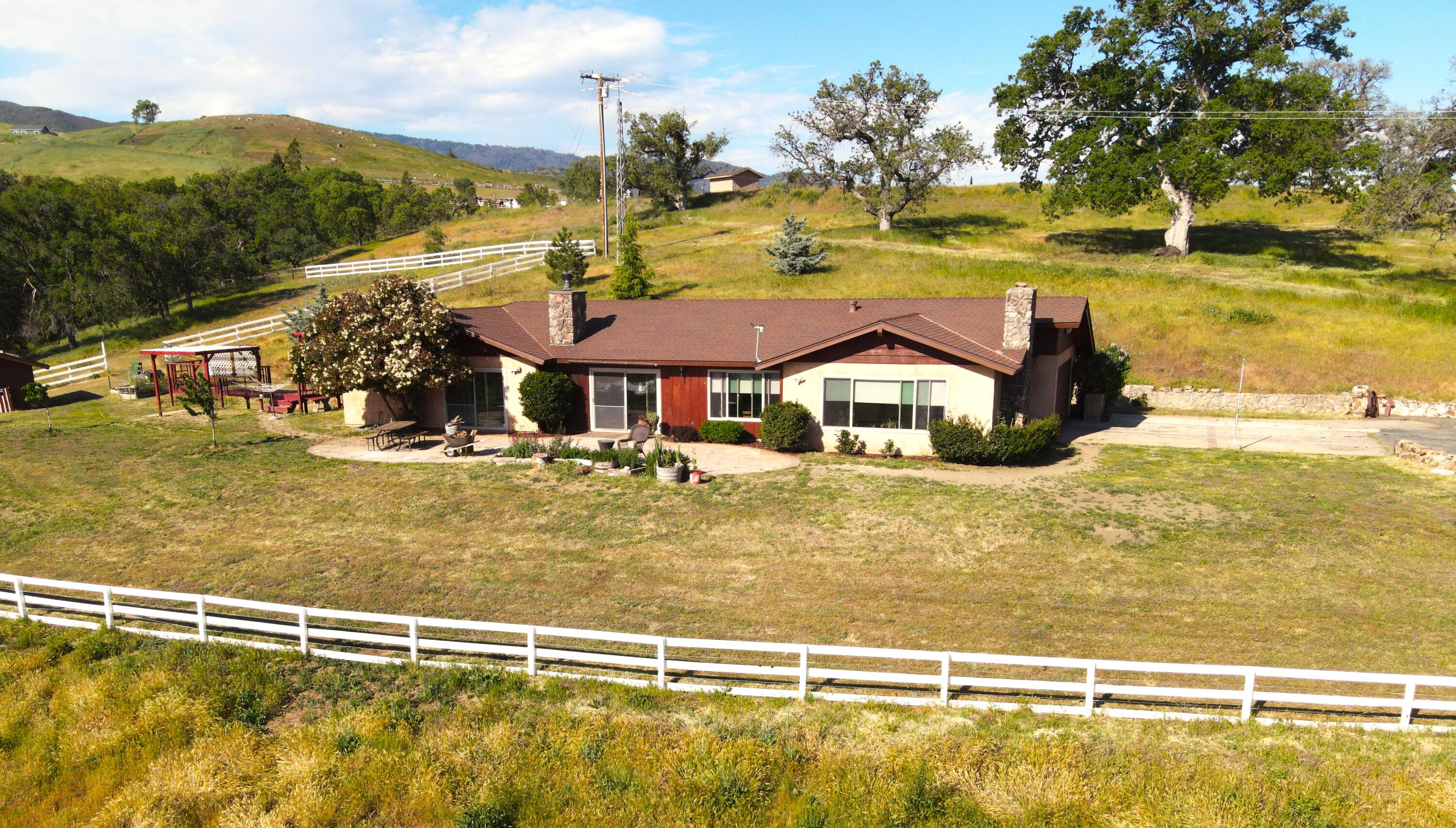 21970 Highline Road Tehachapi, CA 93561 - Photo 68 of 68 a view of a swimming pool with a lawn chairs under an umbrella