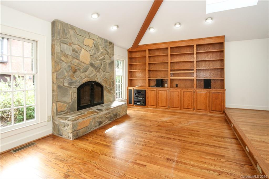 2120 Malvern Road Charlotte, NC 28207 - Photo 17 of 46 a view of an empty room with a fireplace and a window