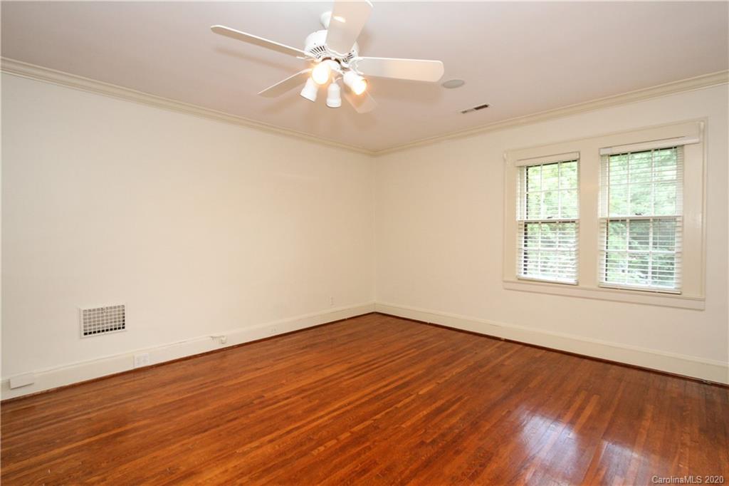 2120 Malvern Road Charlotte, NC 28207 - Photo 19 of 46 an empty room with wooden floor fan and windows