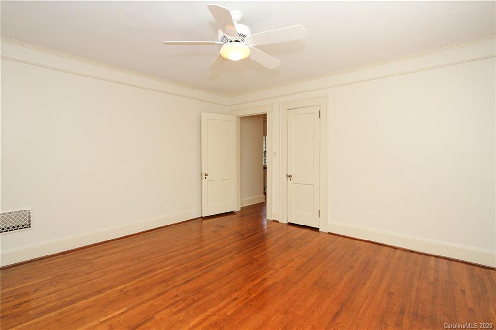 2120 Malvern Road Charlotte, NC 28207 - Photo 24 of 46 an empty room with wooden floor and fan