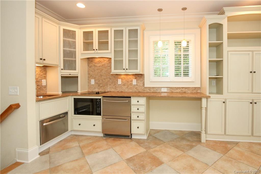 2120 Malvern Road Charlotte, NC 28207 - Photo 28 of 46 a kitchen with granite countertop a stove a sink and a granite counter tops