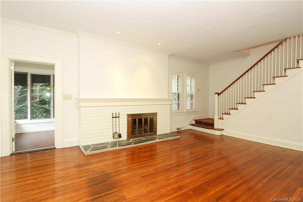 2120 Malvern Road Charlotte, NC 28207 - Photo 4 of 46 a view of an empty room with wooden floor fireplace and a window