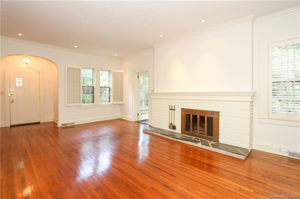 2120 Malvern Road Charlotte, NC 28207 - Photo 5 of 46 an empty room with wooden floor fireplace and windows