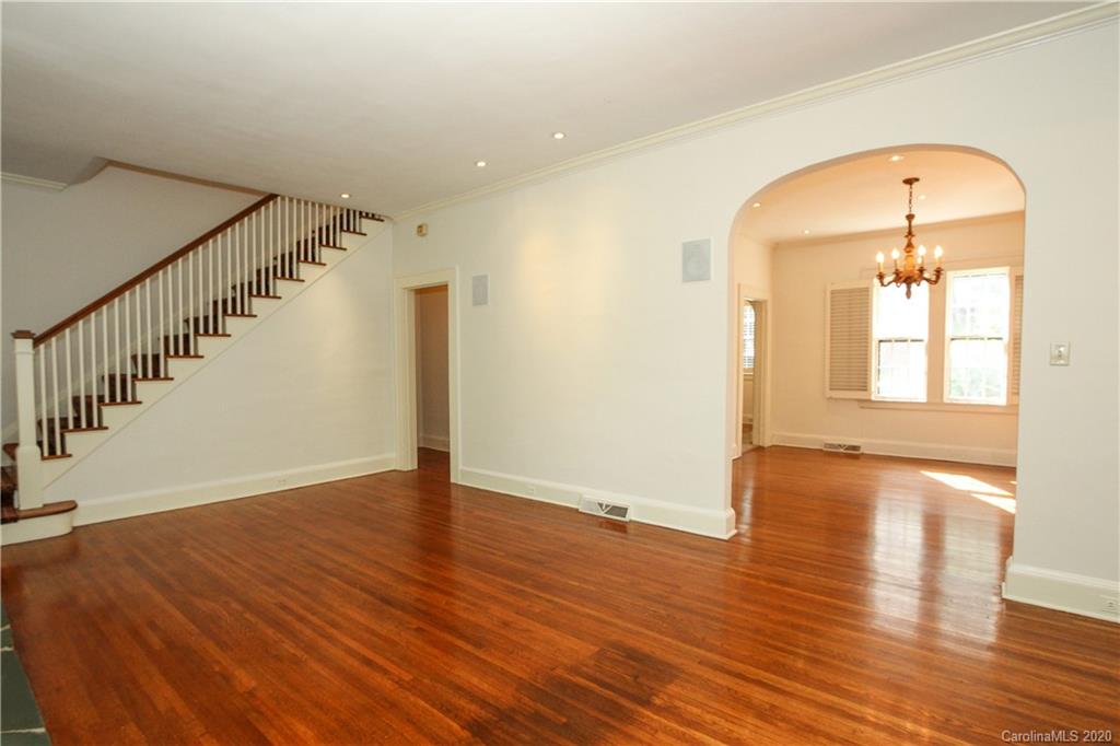 2120 Malvern Road Charlotte, NC 28207 - Photo 6 of 46 a view of an empty room with wooden floor and a window