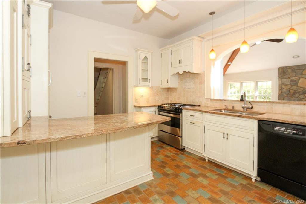 2120 Malvern Road Charlotte, NC 28207 - Photo 10 of 46 a kitchen with granite countertop a sink cabinets stainless steel appliances and a counter space