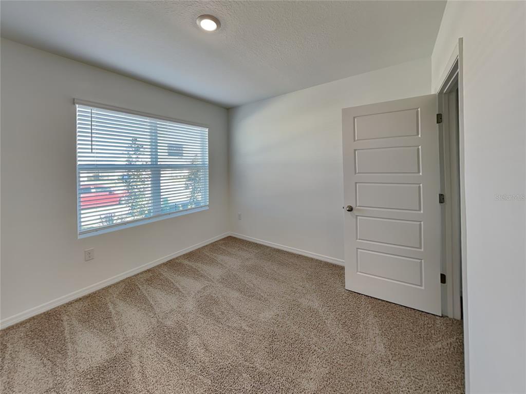 3515 Nettle Loop Tavares, FL 32778 - Photo 13 of 19 an empty room with windows and closet