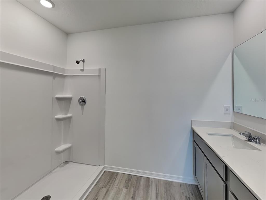 3515 Nettle Loop Tavares, FL 32778 - Photo 14 of 19 a bathroom with a sink toilet and shower