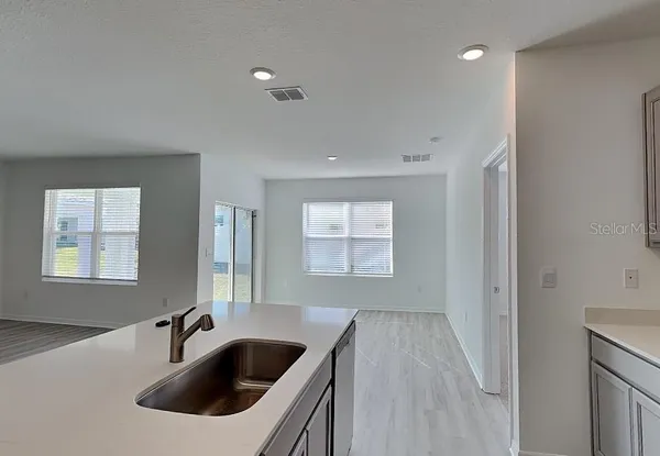 a kitchen with a sink and refrigerator