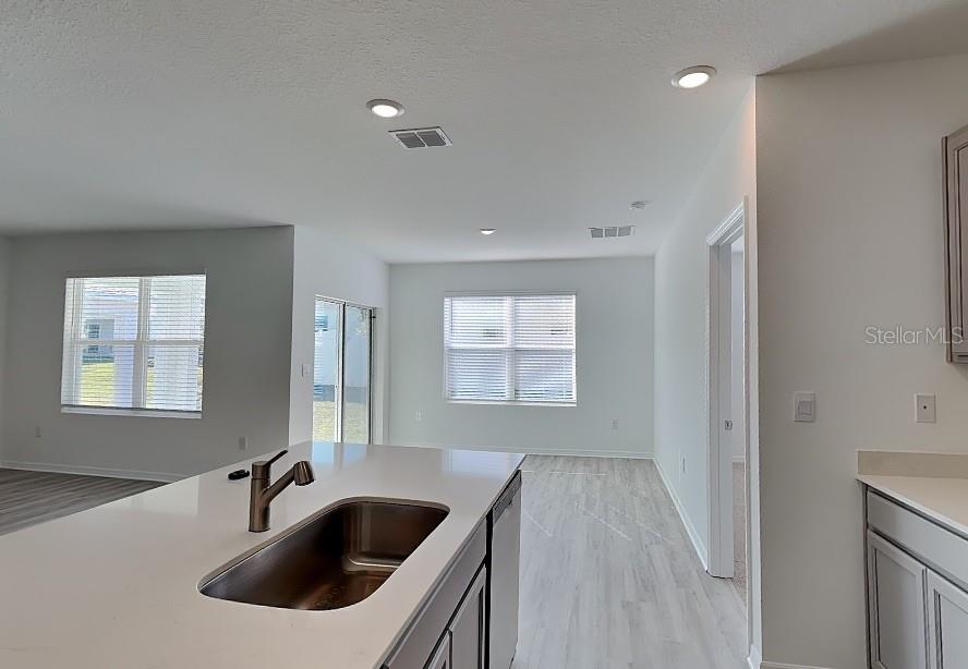 3515 Nettle Loop Tavares, FL 32778 - Photo 4 of 19 a kitchen with a sink and refrigerator