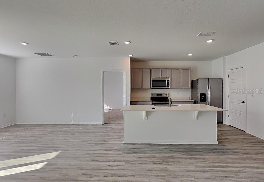 3515 Nettle Loop Tavares, FL 32778 - Photo 5 of 19 a view of kitchen with stainless steel appliances granite countertop a stove top oven and a refrigerator