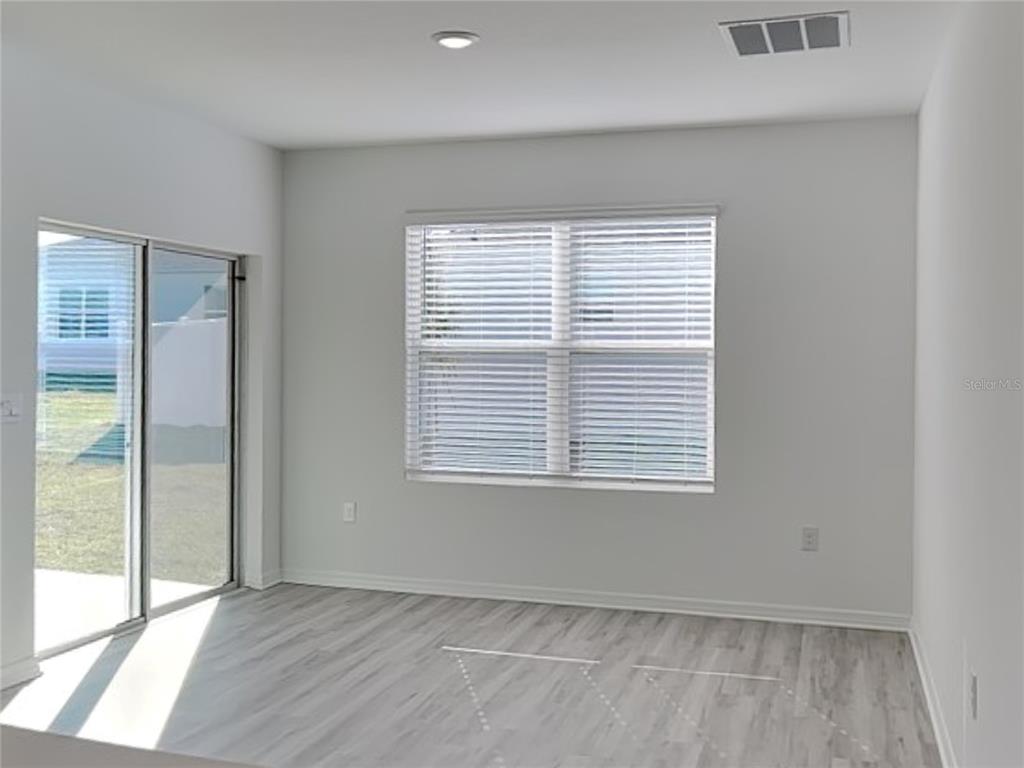 3515 Nettle Loop Tavares, FL 32778 - Photo 8 of 19 a view of an empty room with wooden floor and a window
