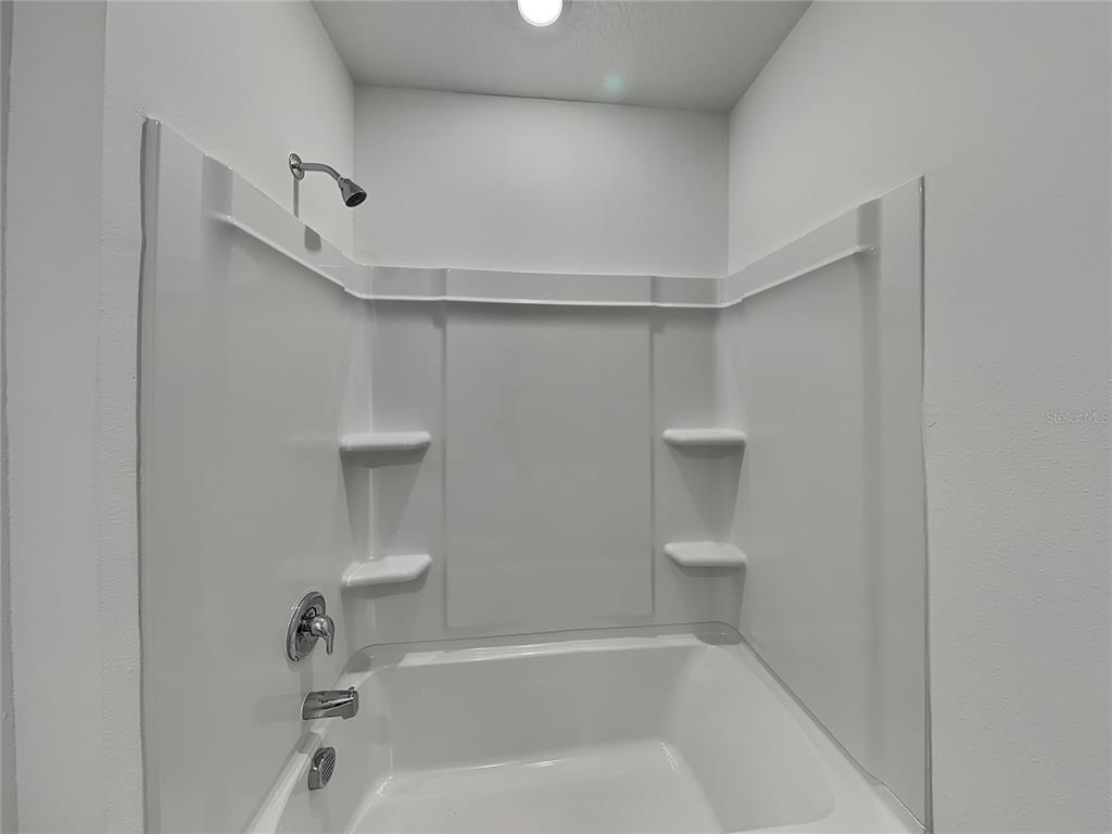 3515 Nettle Loop Tavares, FL 32778 - Photo 9 of 19 a view of a bathroom with a bathtub and toilet