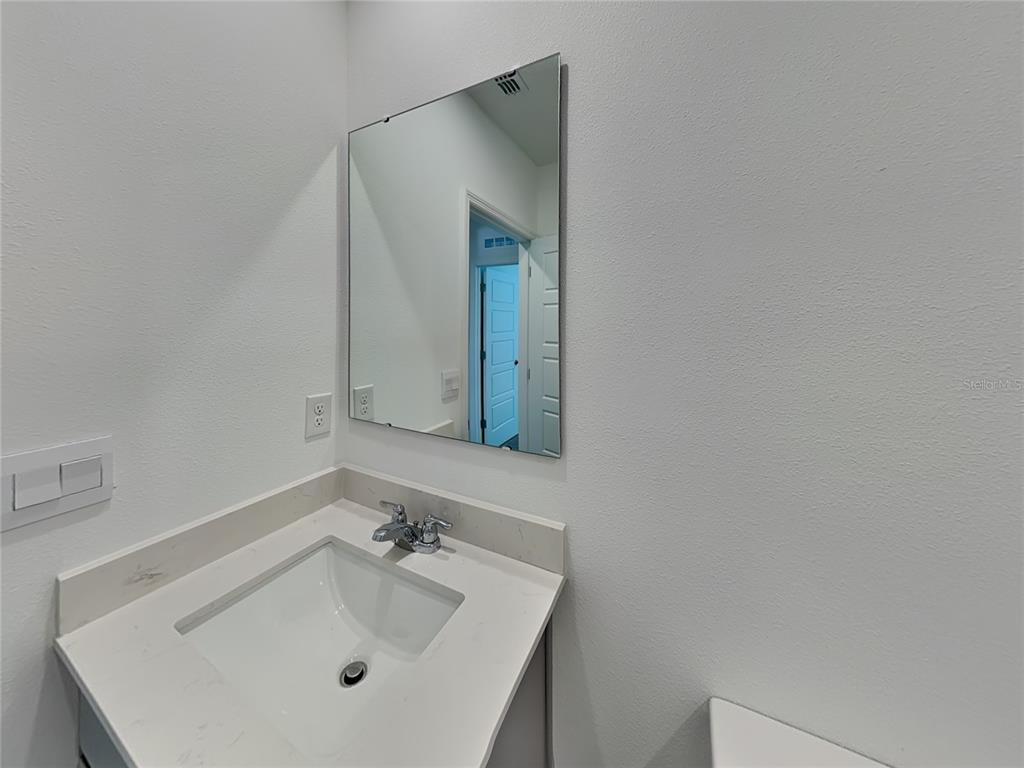 3515 Nettle Loop Tavares, FL 32778 - Photo 10 of 19 a bathroom with a sink and a mirror