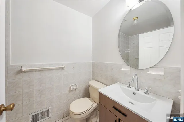 a bathroom with a sink mirror and toilet