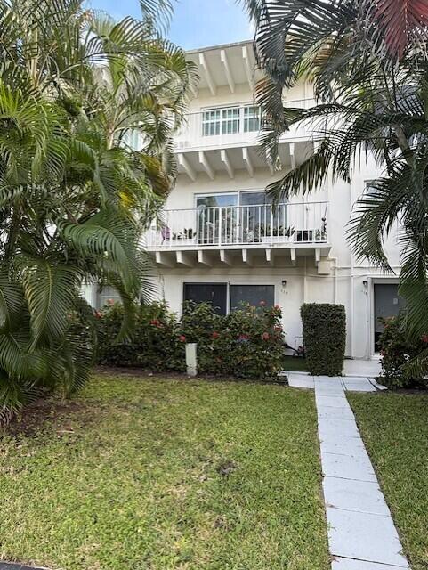 4001 South Ocean Boulevard, Unit 218 South Palm Beach, FL 33480 - Photo 1 of 13 a front view of a house with a garden and plants