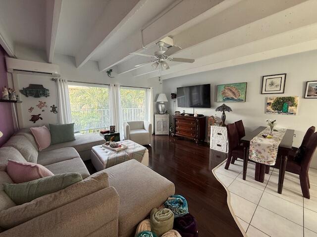 4001 South Ocean Boulevard, Unit 218 South Palm Beach, FL 33480 - Photo 6 of 13 a living room with furniture flat screen tv and a fireplace