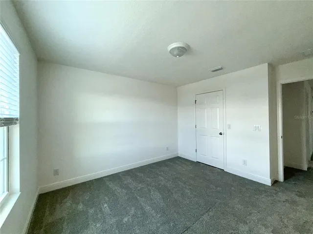 an empty room with a empty space and windows