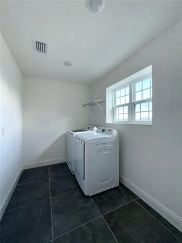 a utility room with a window dryer and washer